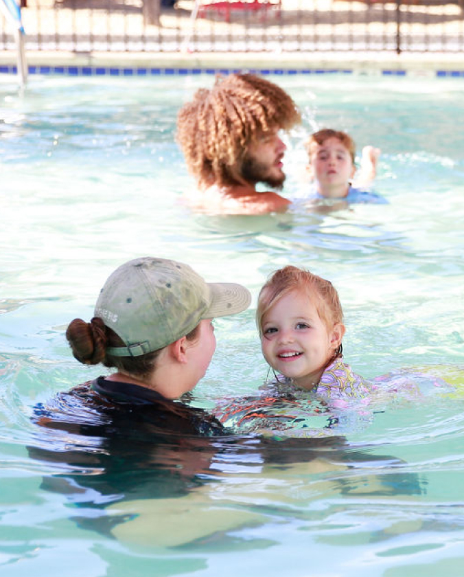 Kids learning how to swim with teachers